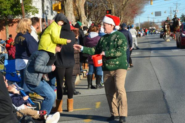 U.S. Sen. Chris Coons (D-Del.) chats with spectators at the Christmas parade, in Elsmere, Del., on Dec. 12, 2021. (Frank Liang/The Epoch Times)