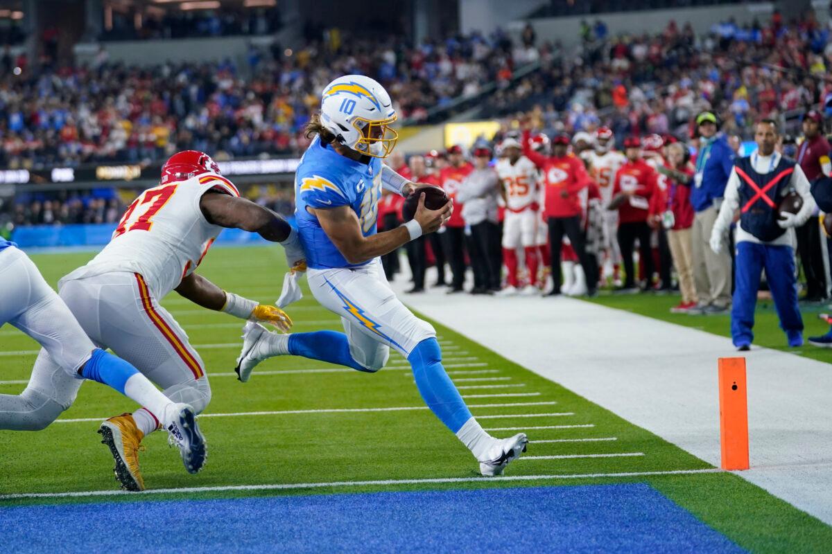 Los Angeles Chargers quarterback Justin Herbert scores a touchdown as Kansas City Chiefs linebacker Darius Harris defends during the first half of an NFL football game Thursday, in Inglewood, Calif., on Dec. 16, 2021. (Marcio Jose Sanchez/AP Photo)
