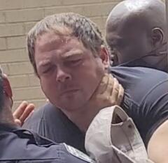 Everett Cooper, a 33-year-old Palm Coast County, Fla. resident was seized, arrested and lead away in handcuffs fr refusing to sit down at an Aug. 25 school board meeting. (Courtesy of Jennifer Showalter)