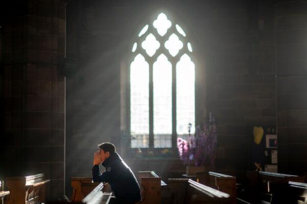 A man prays in a church on Christmas Eve in Birmingham, England, on Dec. 24, 2018. (Christopher Furlong/Getty Images)