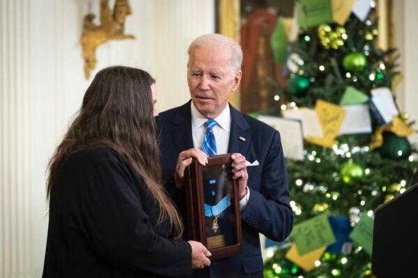 Tamara Cashe, widow of the late Sgt. 1st Class Alwyn C. Cashe, accepts the Medal of Honor on his behalf from President Joe Biden during a ceremony in the East Room of the White House on Dec. 16, 2021. (Drew Angerer/Getty Images)