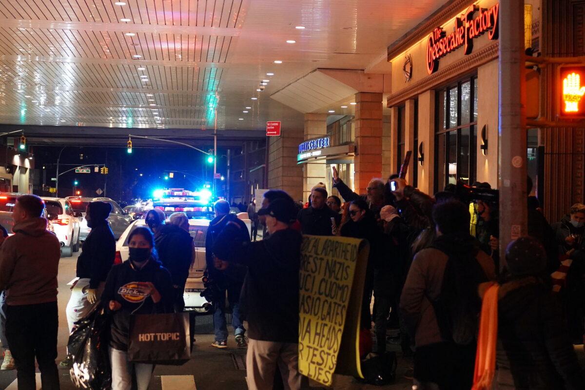 Protestors gather outside Cheesecake Factory, Queens, New York, on Dec. 15, 2021. (Enrico Trigoso/The Epoch Times)