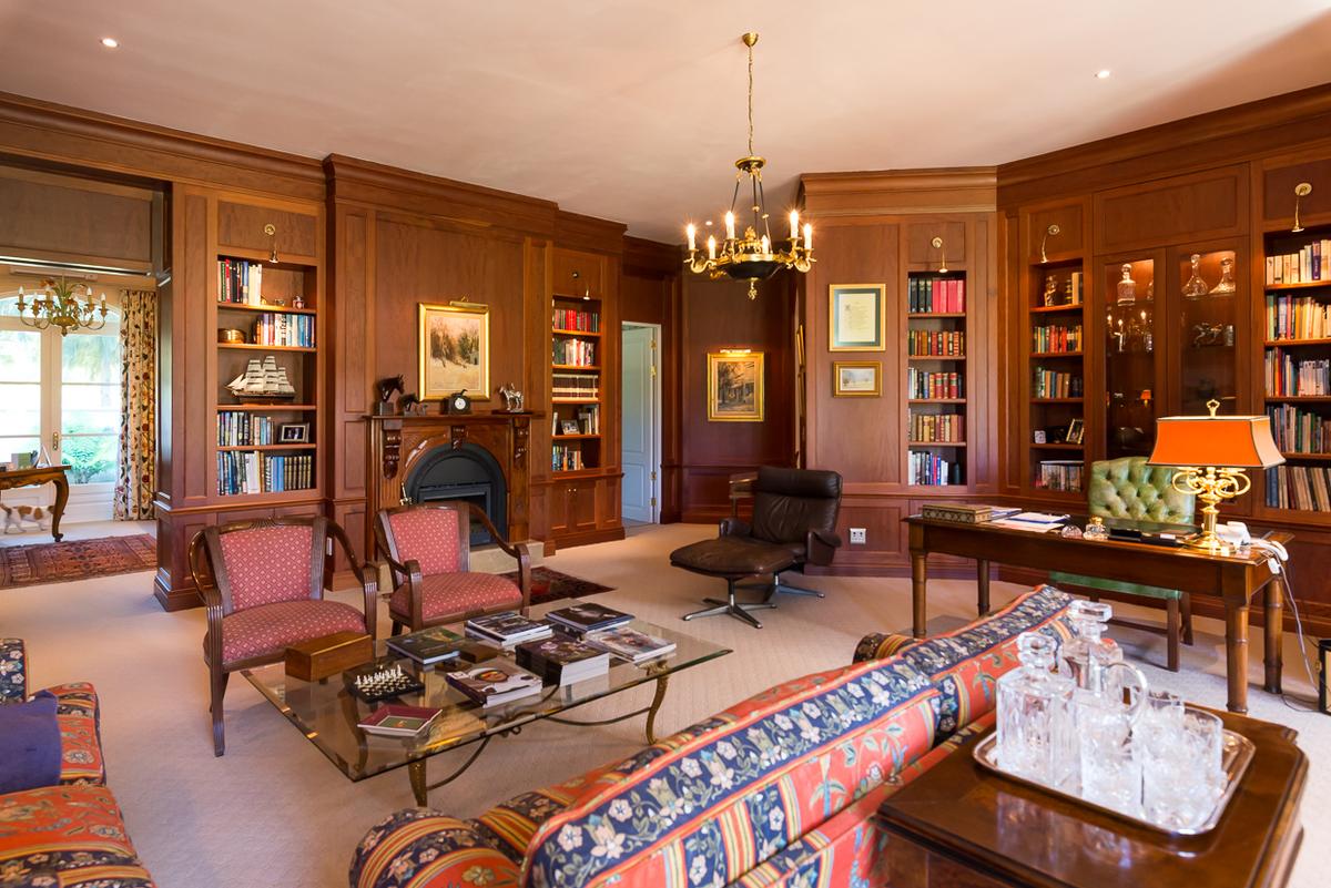 The paneled library reveals the attention to detail and fine craftsmanship that went into this extraordinary home. No expense was spared in either the construction or furnishing of the home. (Courtesy of Val du Lac estate)