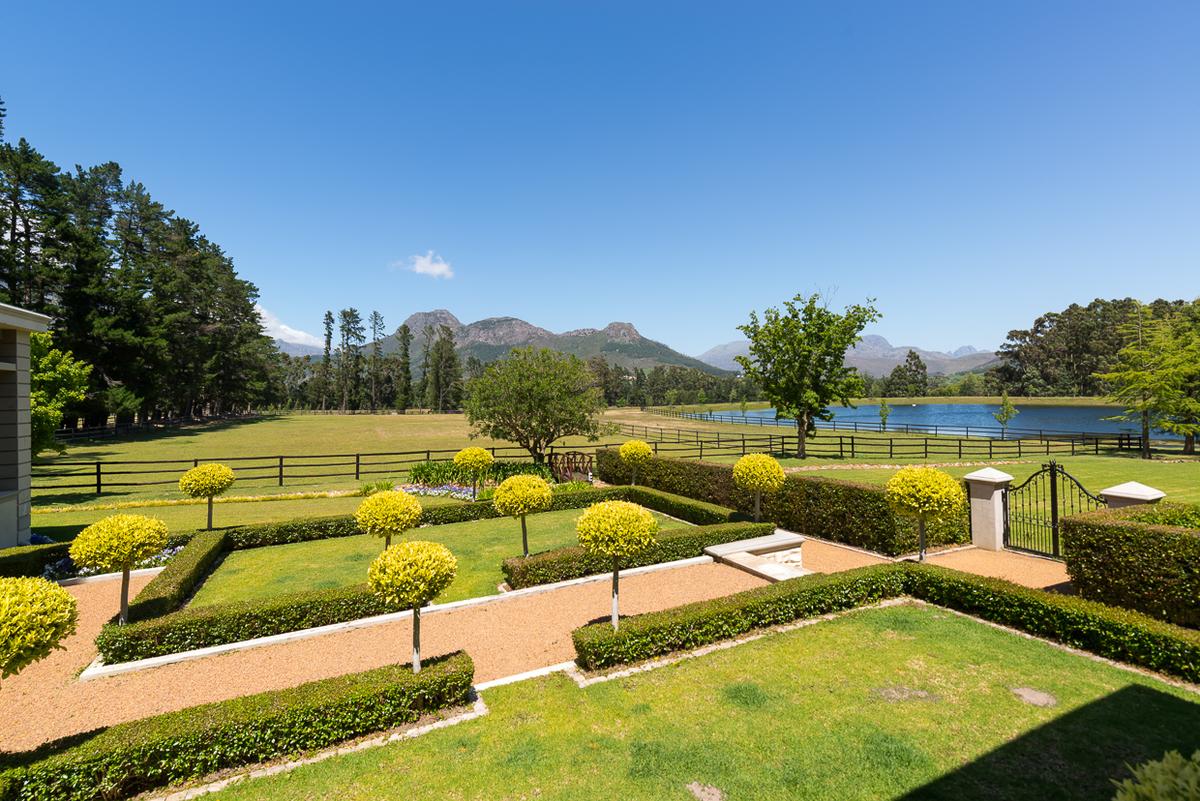 The property includes a tailored garden and a private lake. The forests and fields beyond exude country charm. (Courtesy of Val du Lac estate)
