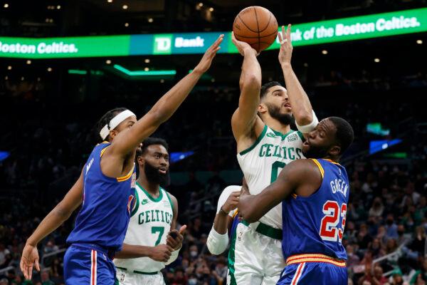 Boston Celtics forward Jayson Tatum (0) drives to the basket as Golden State Warriors forward Draymond Green (23) and guard Moses Moody, left, defend during the first half of an NBA basketball game, in Boston, on Dec. 17, 2021. (Mary Schwalm/AP Photo)