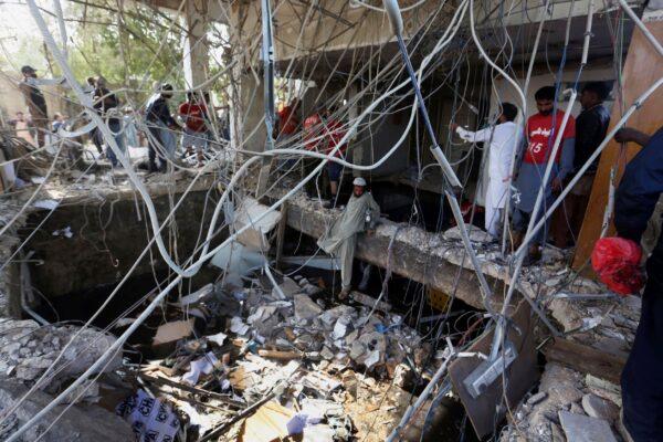 Rescuers inspect the scene of a gas explosion in Karachi, Pakistan, on Dec. 18, 2021. (Fareed Khan/AP Photo)