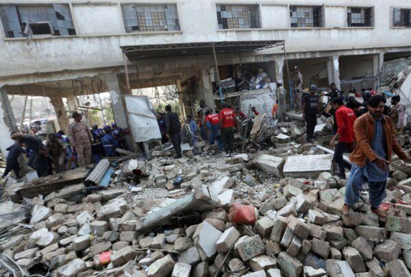 Pakistani security personnel and rescuers inspect the scene of a gas explosion in Karachi, Pakistan, on Dec. 18, 2021. (Fareed Khan/AP Photo)