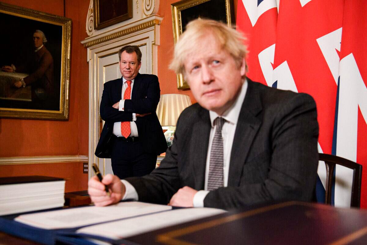 UK chief Brexit negotiator David Frost (L) looks on as Prime Minister Boris Johnson (R) poses for photographs after signing the Brexit trade deal with the EU in number 10 Downing Street in London, on Dec. 30, 2020. (Leon Neal/Getty Images)
