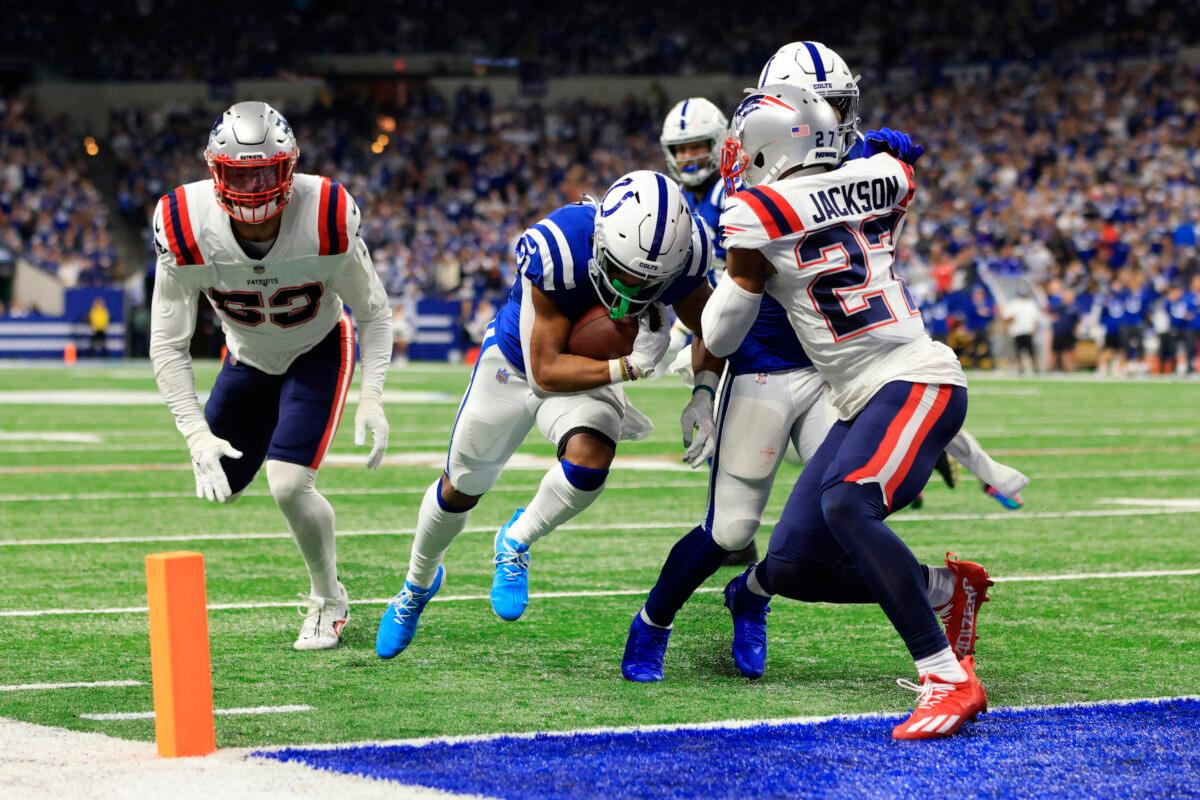 Indianapolis Colts running back Nyheim Hines (C) scores between New England Patriots cornerback J.C. Jackson (27) and middle linebacker Kyle Van Noy (53) during the first half of an NFL football game in Indianapolis, on Dec. 18, 2021. (Aaron Doster/AP Photo)