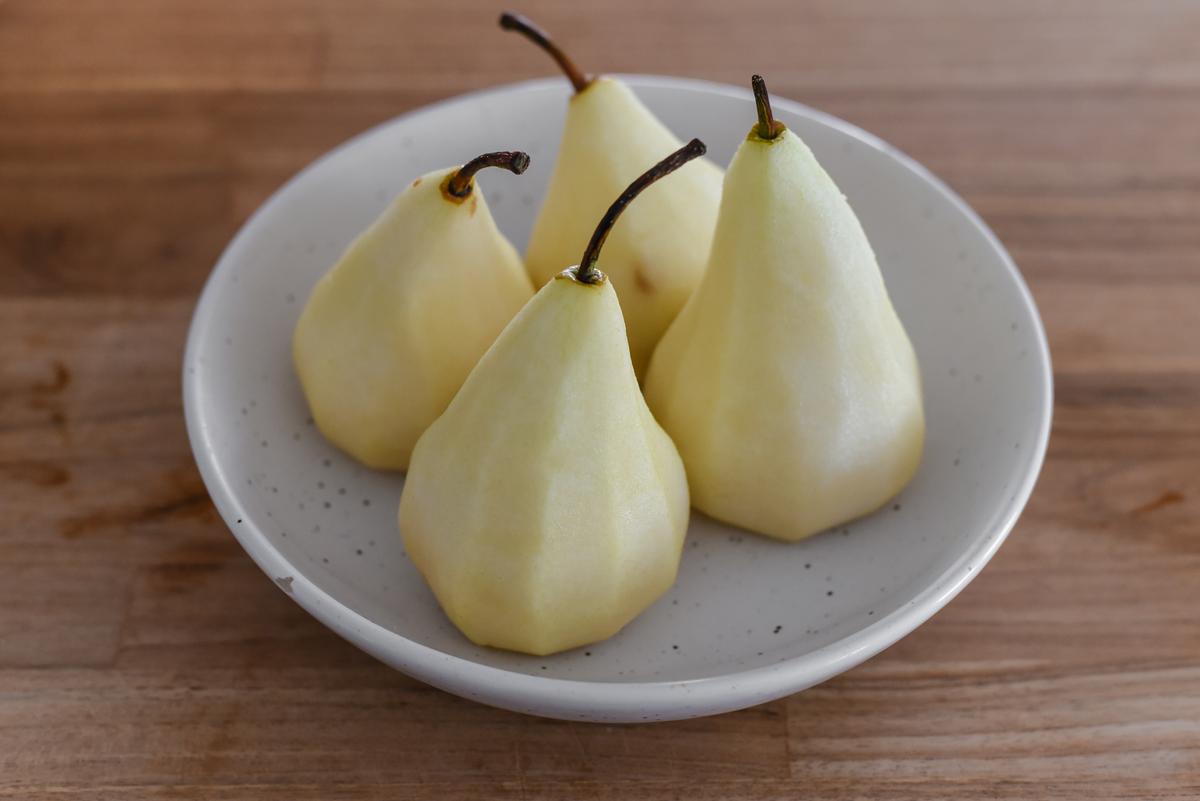 Pear prep: Carefully core the pears from the bottom, cutting out as little as possible, and peel them in large, even strips. (Audrey Le Goff)