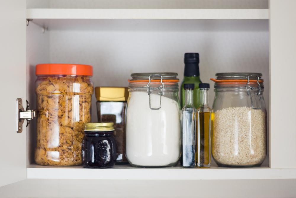 Glass jars for pantry goods maximize shelf space, and make it easy to take inventory. (Miroslav Pesek/Shutterstock)