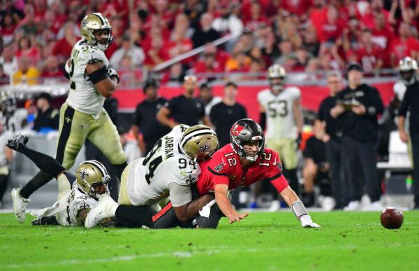 Tom Brady #12 of the Tampa Bay Buccaneers fumbles the ball as he is hit by Cameron Jordan #94 of the New Orleans Saints during the 4th quarter of the game at Raymond James Stadium in Tampa, Fla., on Dec. 19, 2021. (Julio Aguilar/Getty Images)