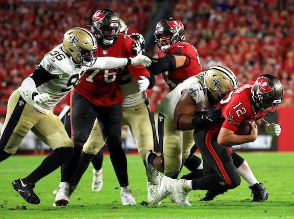Tom Brady #12 of the Tampa Bay Buccaneers is sacked by David Onyemata #93 of the New Orleans Saints during the 4th quarter of the game at Raymond James Stadium, in Tampa, Fla., on Dec. 19, 2021. (Mike Ehrmann/Getty Images)