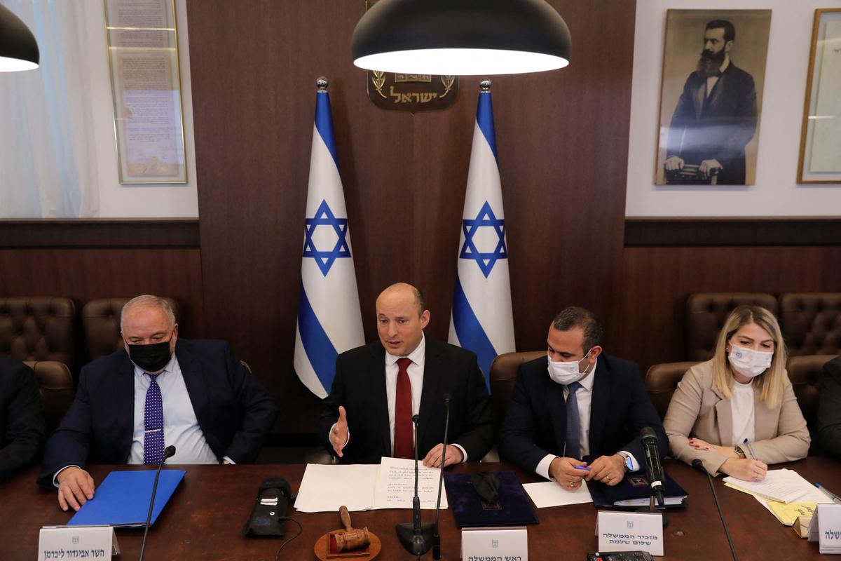 Israeli Prime Minister Naftali Bennett (2-L) and Finance Minister Avigdor Lieberman (L), attend a cabinet meeting in Jerusalem, Israel, on Dec. 19, 2021. (Abir Sultan/POOL/AFP via Getty Images)