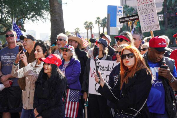 More than 100 people gathered outside the office building of Arizona Attorney General Mark Brnovich in Phoenix in support of election integrity on Dec. 17, 2021. (Allan Stein/The Epoch Times)