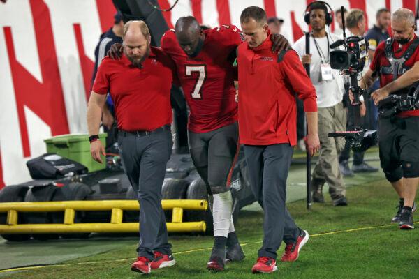Tampa Bay Buccaneers running back Leonard Fournette (7) is helped off the field after getting hurt against the New Orleans Saints during the second half of an NFL football game, in Tampa, Fla., on Dec. 19, 2021. (Mark LoMoglio/AP Photo)