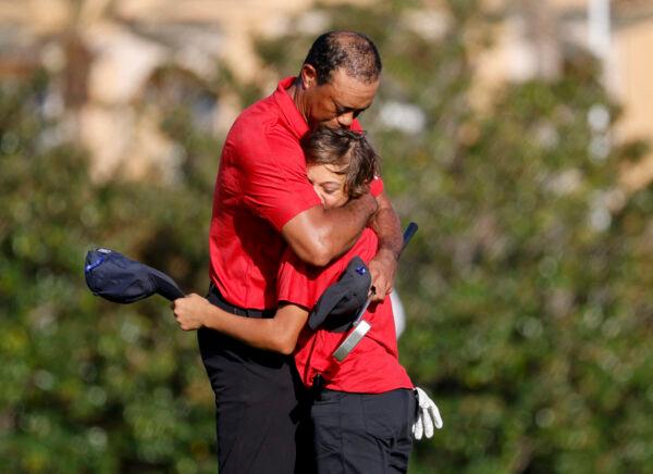 Tiger Woods embraces his son Charlie on the 18th green during the second round of the PNC Championship golf tournament in Orlando, Fla., on Dec. 19, 2021. (Joe Skipper/Reuters)