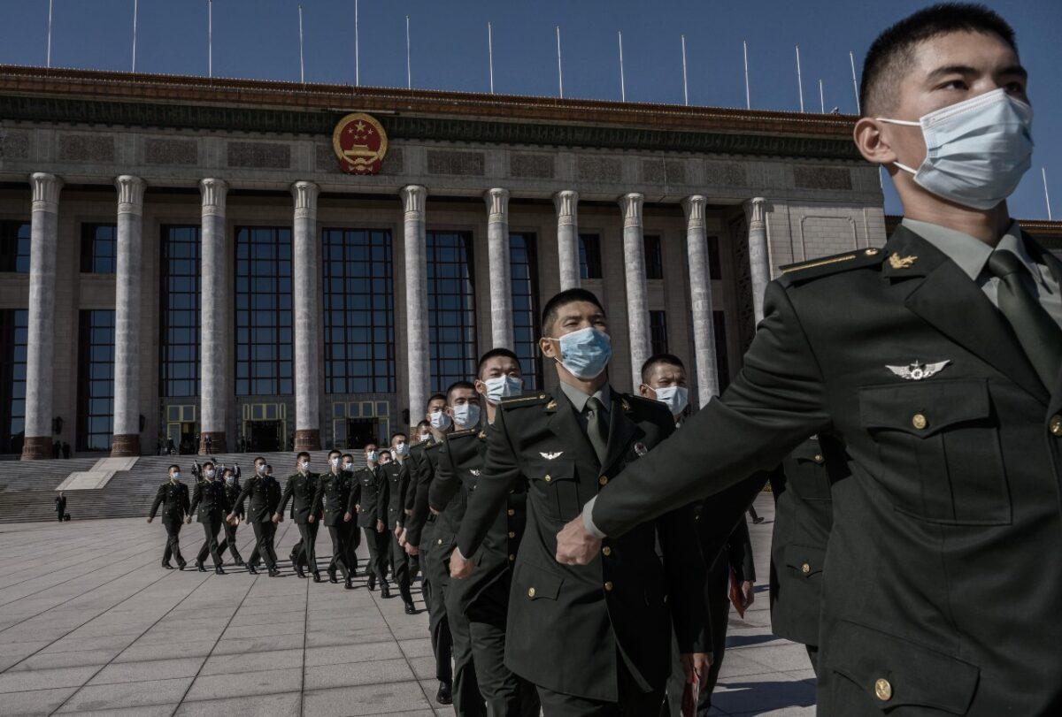 Chinese soldiers from the People’s Liberation Army wear masks as they march after a ceremony marking the 70th anniversary of China’s entry into the Korean War at the Great Hall of the People in Beijing on Oct. 23, 2020. (Kevin Frayer/Getty Images)