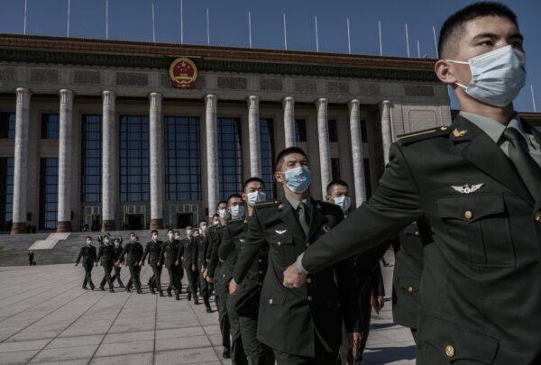 Chinese soldiers from the People's Liberation Army wear protective masks as they march after a ceremony marking the 70th anniversary of China's entry into the Korean War, on Oct. 23, 2020 at the Great Hall of the People in Beijing, China. (Kevin Frayer/Getty Images)