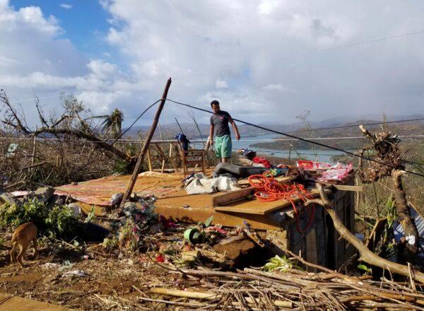 A man checks his damaged home due to Typhoon Rai at Dinagat islands, southern Philippines, on Dec. 19, 2021. (Office of the Vice President via AP)
