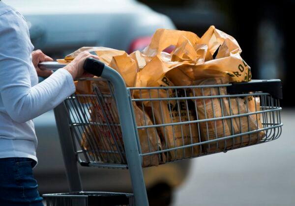 A women leaves a grocery store using plastic bags in Mississauga, Ont., in a file photo. (The Canadian Press/Nathan Denette)