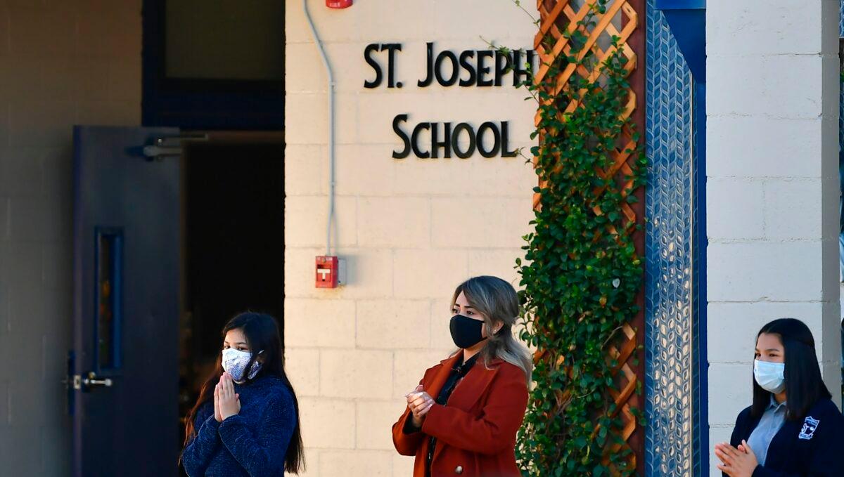 Students attend morning prayers in the courtyard at St. Joseph Catholic School in La Puente, Calif., on Nov. 16, 2020. (Frederic J. Brown/AFP via Getty Images)