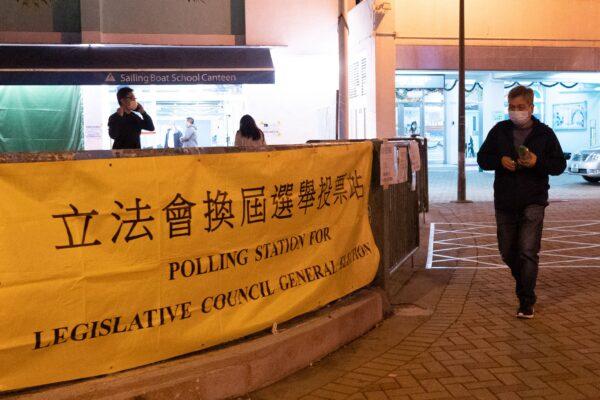  A voter leaves a polling station during the Legislative Council election in Hong Kong's Choi Hung area on Dec. 19, 2021. (Bertha Wang/AFP via Getty Images)