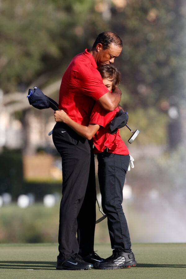 Tiger Woods hugs son Charlie Woods on the 18th green after the second round of the PNC Championship golf tournament in Orlando, Fla. on Dec. 19, 2021. (Scott Audette/AP Photo)