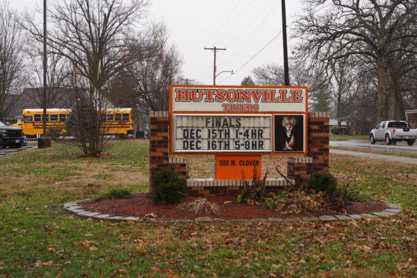 A sign displays sports schedules outside Hutsonville High School in Hutsonville, Ill., on Dec. 17, 2021. (Cara Ding/The Epoch Times)