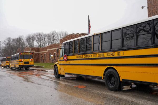 School buses waiting outside the Hutsonville public school district's building on the last school day before holiday season on Dec. 17, 2021. (Cara Ding/The Epoch Times)