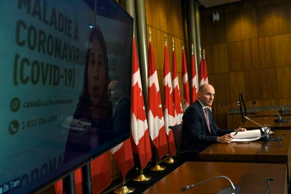 Minister of Health Jean-Yves Duclos and Chief Public Health Officer of Canada Dr. Theresa Tam, appearing via videoconference, participate in a news conference on the COVID-19 pandemic and the Omicron variant, in Ottawa, on Dec. 17, 2021. (The Canadian Press/Justin Tang)