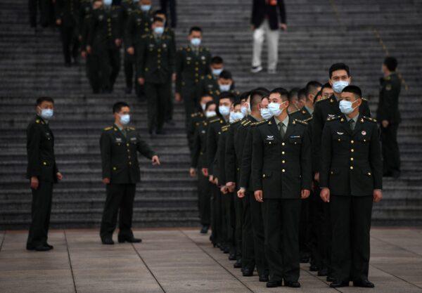 Military delegates stand in formation at the Great Hall of the People in Beijing on Oct. 9, 2021. (Noel Celis/AFP via Getty Images)