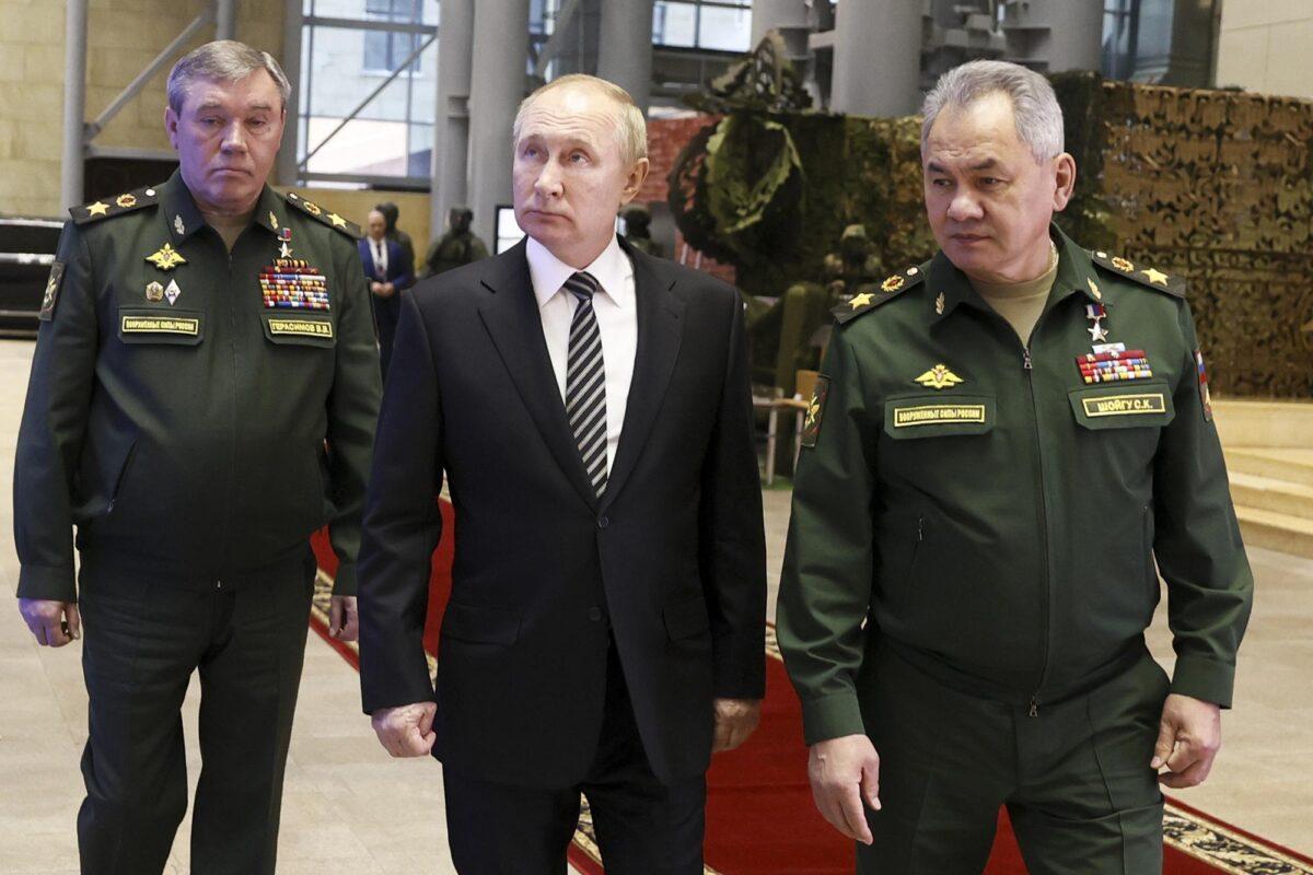 Russian President Vladimir Putin, center, escorted by Russian Defense Minister Sergei Shoigu, right, and General Staff Valery Gerasimov walk after attending an extended meeting of the Russian Defense Ministry Board at the National Defense Control Center in Moscow, Russia, on Dec. 21, 2021. (Mikhail Metzel, Sputnik, Kremlin Pool Photo via AP)