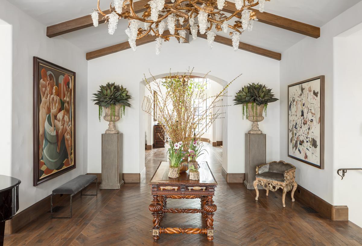 The redesign of the home shows off a traditional Mediterranean style with chic modern accents. For the visitor, the tastefully done hallways entice with a generous use of fine stone, and rare wood throughout the residence. (Matthew Walla/Jade Mills)