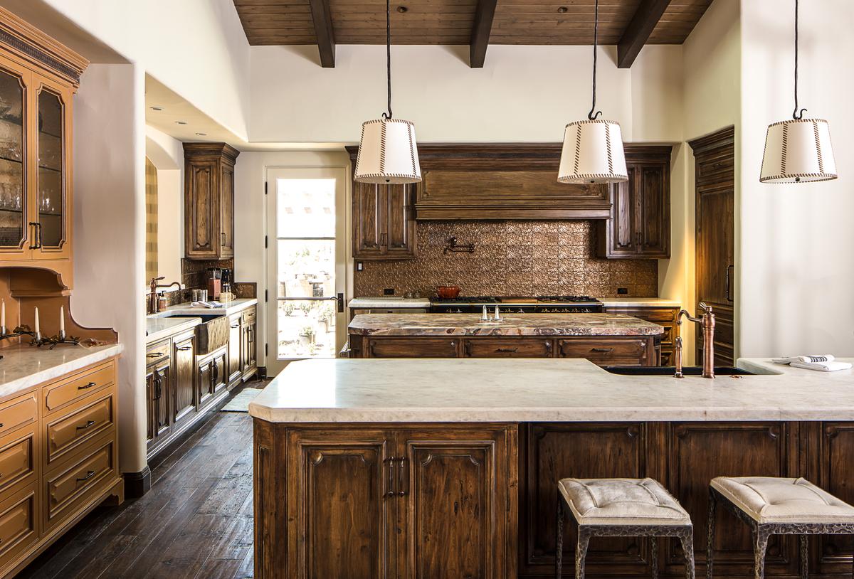 The main kitchen of the residence is another tastefully done space that blends warm aesthetics with utility. A second kitchen beneath this floor serves guests in the estate’s exquisite wine cellar. (Matthew Walla/Jade Mills)