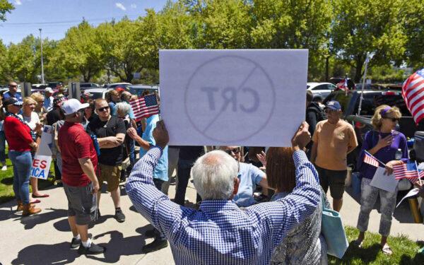 A man holds up a sign against Critical Race Theory during a protest outside a Washoe County School District board meeting in Reno, Nev., on May 25, 2021. (Andy Barron/Reno Gazette-Journal via AP)