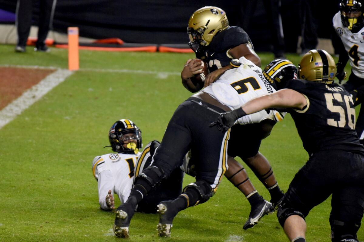 Missouri defensive lineman Darius Robinson (6) is unable to stop Army running back Jakobi Buchanan, center top, who reached the end zone for a touchdown on a running play in the second half of the Armed Forces Bowl NCAA college football game in FORT WORTH, Texas, on Dec. 22, 2021. (Emil Lippe/AP Photo)