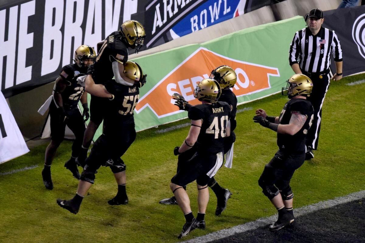 Army running back Brandon Walters, second from left, is lifted by offensive lineman Cooper Smith (50) as running back Cade Barnard (40) and others celebrate a touchdown scored by Walters on a pass play in the second half of the Armed Forces Bowl NCAA college football game against Missouri in FORT WORTH, Texas, on Dec. 22, 2021. (Emil Lippe/AP Photo)