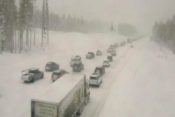 In this image taken from video from a Caltrans remote video traffic camera, traffic is stopped along a snow covered Interstate 80 at Donner Summit, Calif., on Dec. 23, 2021. (Caltrans via AP)