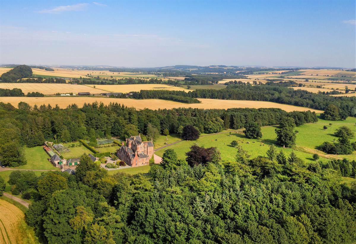 Another aerial view of the castle and the magnificent acres surrounding it. In all, there are 144 acres of arable farmland, about 30 acres of permanent pasture, 138 acres of woodlands, and 33 additional acres for mixed use. (Courtesy of Itago Media Ltd.)