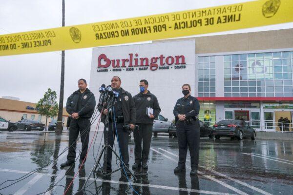 Los Angeles Police Department Public Information Officer Capt. Stacy Spell (2nd L) speaks in a press conference at the scene where two people were struck by gunfire in a shooting at a Burlington store in North Hollywood, Calif., on Dec. 23, 2021. (Ringo H.W. Chiu/AP Photo)
