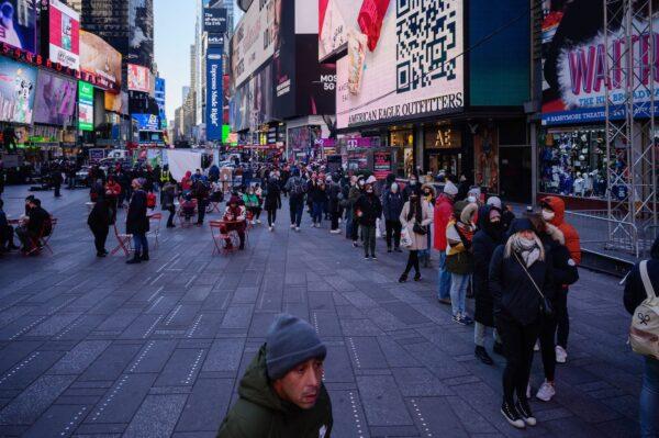 People queue at a street-side Covid-19 testing booth in New York's Times Square on Dec. 20, 2021.(Ed Jones/AFP via Getty Images)