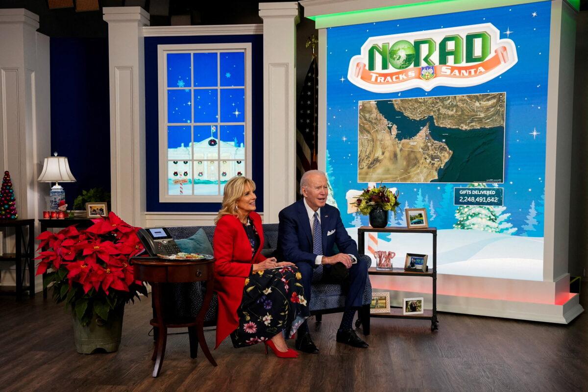 President Joe Biden and First Lady Jill Biden participate in NORAD Santa tracker phone calls from South Court Auditorium at the White House on Dec. 24, 2021. (Elizabeth Frantz/Reuters)