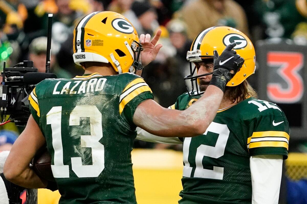 Green Bay Packers' Aaron Rodgers is congratulated after throwing his 443rd career touchdown pass, during the first half of an NFL football game against the Cleveland Browns. The pass broke the Packers record held by Brett Favre, in Green Bay, Wis., on Dec. 25, 2021. (Morry Gash/AP Photo)