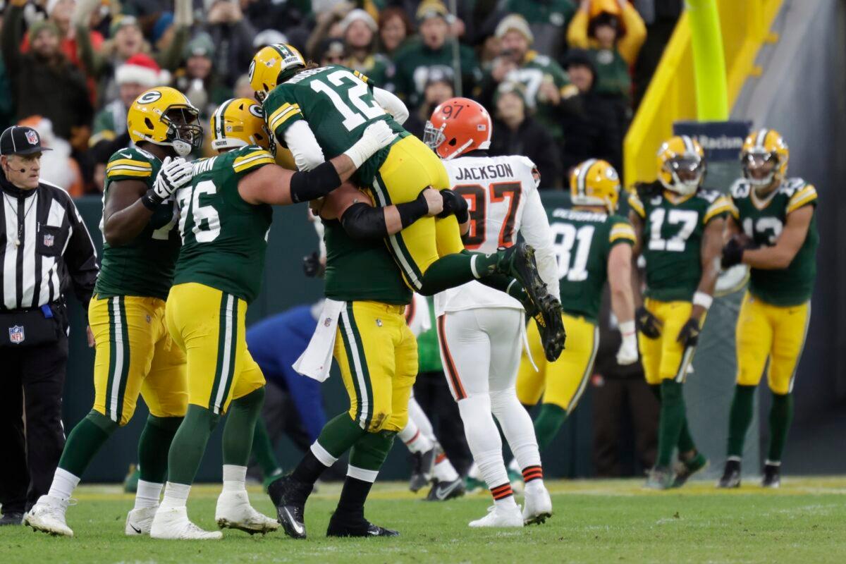 Green Bay Packers' Aaron Rodgers is congratulated after throwing career touchdown pass 443 during the first half of an NFL football game against the Cleveland Browns, in Green Bay, Wis., on Dec. 25, 2021. (Matt Ludtke/AP Photo)