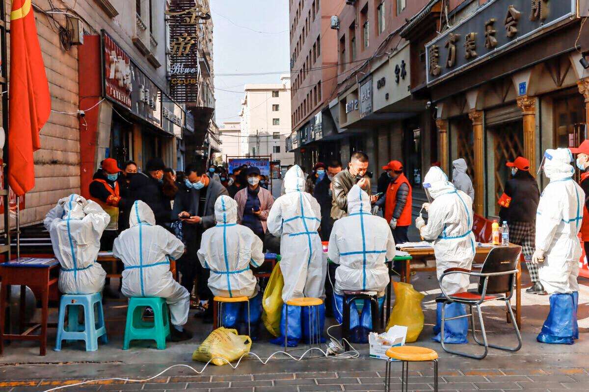 Medical staff members conduct nucleic acid tests for the COVID-19 coronavirus in Zhangye in China's northwestern Gansu Province, on Oct. 23, 2021. (STR/AFP via Getty Images)