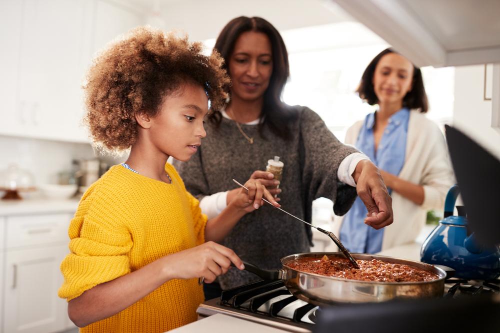 Getting children to help with dinner duties gets them more invested in the family ritual. (Monkey Business Images/Shutterstock)