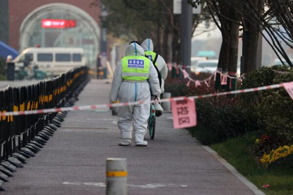 Security guards walking in an area that is under restrictions following a recent coronavirus outbreak in Xi'an city, Shaanxi Province, China, on Dec. 22, 2021. (STR/AFP via Getty Images)