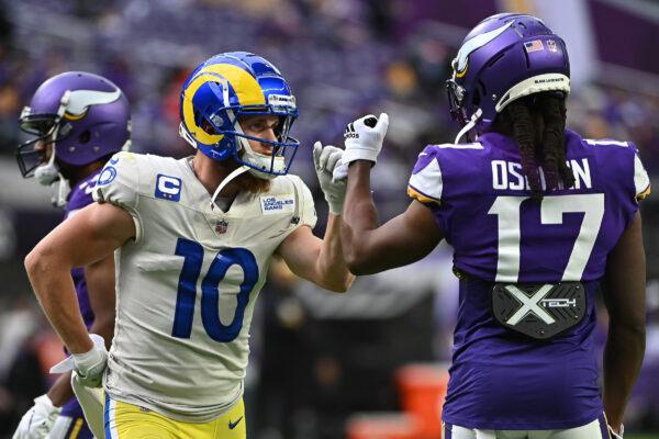 Cooper Kupp #10 of the Los Angeles Rams and K.J. Osborn #17 of the Minnesota Vikings bump fists during a warm-up before their game at U.S. Bank Stadium in Minneapolis, Minn., on Dec. 26, 2021. (Stephen Maturen/Getty Images)