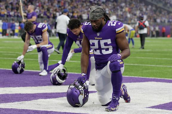 Alexander Mattison #25 of the Minnesota Vikings kneels in the end zone and takes a moment to himself during pre-game against the Los Angeles Rams at U.S. Bank Stadium, in Minneapolis, Minn., on Dec. 26, 2021. (David Berding/Getty Images)